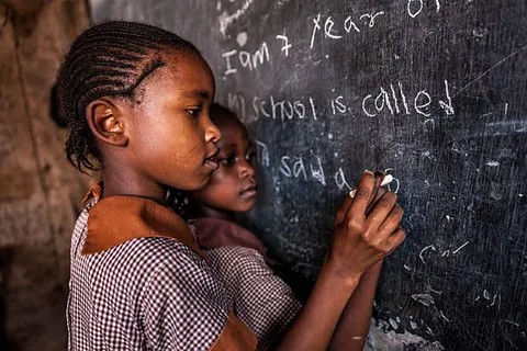 a-student-writing-with-chalk-on-a-classroom-blackboard