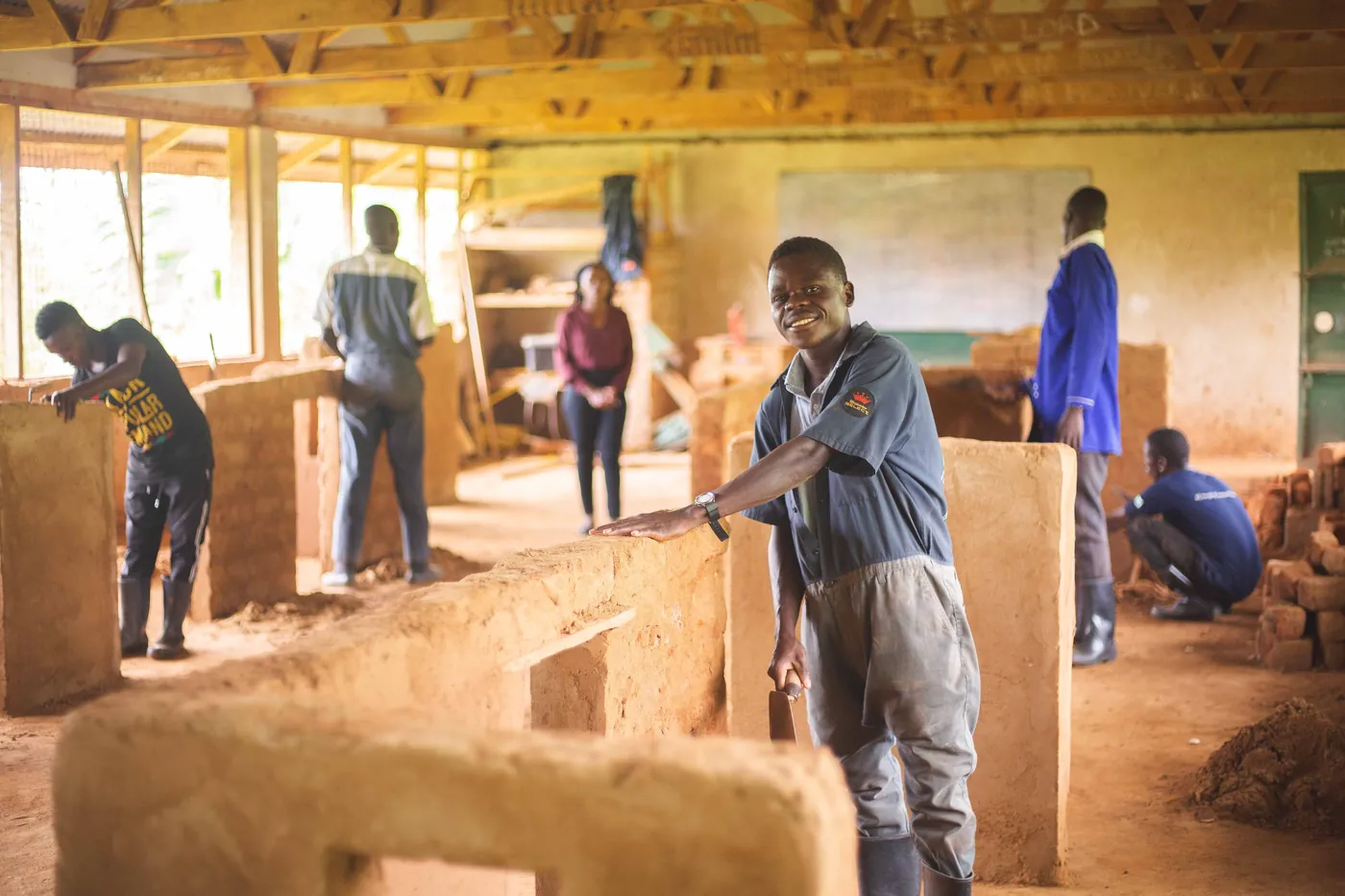 People working on masonry inside a building with exposed walls and ceiling. people-working-on-masonry-inside-a-building-with-exposed-walls-and-ceiling-for-owaid-orphan-and-widow-support